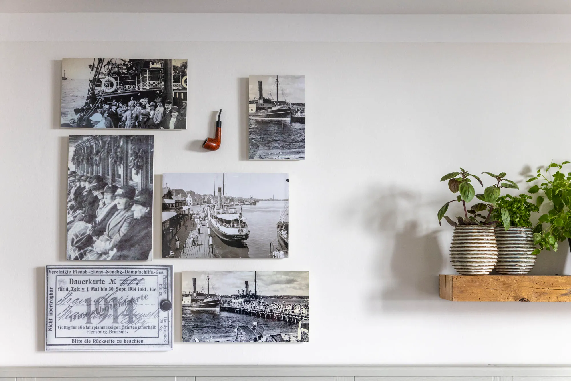 Historic harbour photograph and a captain’s cap above the bed